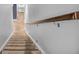 Carpeted staircase with wooden handrail and soft lighting, providing safe passage between floors at 7897 Hickory Ridge Ln, Mooresville, IN 46158