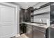 A well-appointed wet bar in the finished basement, featuring dark cabinets, open shelving, and stylish countertops at 7897 Hickory Ridge Ln, Mooresville, IN 46158