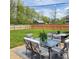 Fenced backyard features a patio with ample seating and a lush lawn, creating a perfect outdoor space at 8136 E 37Th Pl, Indianapolis, IN 46226