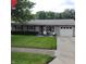 Charming single-story home featuring a well-maintained lawn and an attached one car garage at 8136 E 37Th Pl, Indianapolis, IN 46226