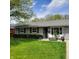 Charming single-story home with well-manicured lawn, inviting entrance, and tidy landscaping at 8136 E 37Th Pl, Indianapolis, IN 46226
