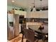 Bright eat-in kitchen with stainless steel appliances, black backsplash and overhead decorative lighting at 8136 E 37Th Pl, Indianapolis, IN 46226