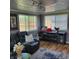 Relaxing living room featuring a plush sofa, modern entertainment center, and hardwood floors at 8136 E 37Th Pl, Indianapolis, IN 46226