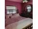 The main bedroom offers a serene retreat with coordinated decor, wood floors, and a ceiling fan at 8136 E 37Th Pl, Indianapolis, IN 46226