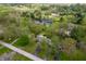 Aerial view of home with a pond and inground pool in a lush, green neighborhood at 8245 Woodlawn Dr, Martinsville, IN 46151