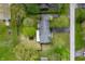 Aerial view of a charming home surrounded by mature trees and lush landscaping at 8245 Woodlawn Dr, Martinsville, IN 46151