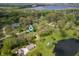 Aerial view of a home surrounded by lush greenery, ponds, and located in a serene neighborhood at 8245 Woodlawn Dr, Martinsville, IN 46151