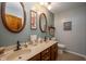 Bathroom with double sinks and wood-trimmed vanity at 8245 Woodlawn Dr, Martinsville, IN 46151