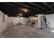 Unfinished basement with painted ceilings, concrete floors, and access to upper level stairs at 825 Iowa St, Indianapolis, IN 46203