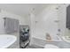 Bright bathroom featuring tiled shower over tub, gray-scale color palette, and a vessel sink at 825 Iowa St, Indianapolis, IN 46203