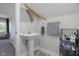 Bathroom showcasing a pedestal sink, neutral paint, and a view into the bedroom at 825 Iowa St, Indianapolis, IN 46203