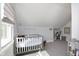 Bright Bedroom with cozy crib, soft carpet, and a serene atmosphere for a comforting space at 825 Iowa St, Indianapolis, IN 46203