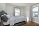 Comfortable bedroom featuring a cozy bed, hardwood floors, and natural light from dual windows at 825 Iowa St, Indianapolis, IN 46203