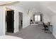 Open bedroom layout featuring carpet, vaulted ceilings, and two entryways into bathrooms at 825 Iowa St, Indianapolis, IN 46203