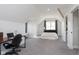 Spacious bedroom featuring vaulted ceilings, carpet, a dedicated office area, and natural light at 825 Iowa St, Indianapolis, IN 46203