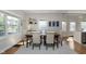Bright dining room with large windows, a stylish table, and comfortable upholstered chairs at 825 Iowa St, Indianapolis, IN 46203