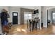 Cozy entryway featuring hardwood floors, a built-in table, and a view of the front door and living area at 825 Iowa St, Indianapolis, IN 46203