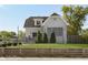 Attractive home showcasing manicured lawn, inviting porch and wood fence for added curb appeal at 825 Iowa St, Indianapolis, IN 46203