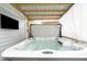 Open hot tub area with cover and seating nearby, perfect for relaxing outdoors at 825 Iowa St, Indianapolis, IN 46203