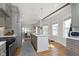Spacious kitchen with stainless steel appliances, stylish island with seating, and a view into the dining area at 825 Iowa St, Indianapolis, IN 46203