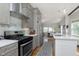 Well-equipped kitchen featuring stainless steel appliances, subway tile backsplash, and an adjacent dining area at 825 Iowa St, Indianapolis, IN 46203