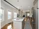 Sunlit kitchen showcasing modern island with seating, stainless steel appliances, and hardwood floors at 825 Iowa St, Indianapolis, IN 46203