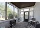 Inviting sunroom featuring brick walls, many windows and comfortable seating for enjoying the outdoors at 825 Iowa St, Indianapolis, IN 46203
