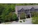 Aerial view of townhomes with brick facade surrounded by lush green trees at 877 Rosalind Pl, Carmel, IN 46032