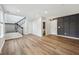 Finished basement featuring new vinyl floors, a modern staircase, and ample lighting at 877 Rosalind Pl, Carmel, IN 46032