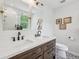 Bright bathroom featuring dual sinks, a large mirror, and decorative floor tiles at 877 Rosalind Pl, Carmel, IN 46032