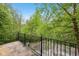 Wood deck overlooking green trees, secured by a black metal fence at 877 Rosalind Pl, Carmel, IN 46032
