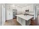 Bright kitchen featuring a spacious island, stainless steel appliances, and custom white cabinetry for ample storage at 877 Rosalind Pl, Carmel, IN 46032