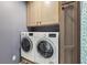 Laundry room features side-by-side washer and dryer and storage cabinet at 877 Rosalind Pl, Carmel, IN 46032