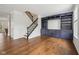 Open living room with a staircase, custom built-in shelving, hardwood flooring, and plenty of natural light at 877 Rosalind Pl, Carmel, IN 46032