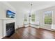 Inviting living area with fireplace, media console, and natural light from large windows at 877 Rosalind Pl, Carmel, IN 46032