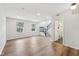 Spacious living room featuring vinyl floors, large windows, and easy access to a bathroom at 877 Rosalind Pl, Carmel, IN 46032