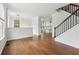 Inviting living room featuring hardwood floors, neutral walls, and a staircase with black railing at 877 Rosalind Pl, Carmel, IN 46032