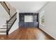 Bright living room features custom built-in shelving, hardwood floors, and natural light from a large window at 877 Rosalind Pl, Carmel, IN 46032