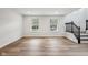 Bright living room with new vinyl floors, large windows, and a view to the front yard at 877 Rosalind Pl, Carmel, IN 46032