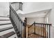 Staircase with a black railing leading to a lower level with new vinyl floors at 877 Rosalind Pl, Carmel, IN 46032