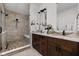 Elegant bathroom with a double vanity, stone countertops, and a walk-in shower at 904 Veterans Way, Carmel, IN 46032