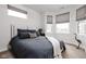 Serene bedroom featuring large windows, neutral tones, and elegant finishes at 904 Veterans Way, Carmel, IN 46032
