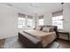 Bright bedroom featuring neutral tones, stylish pendant lighting, and large windows at 904 Veterans Way, Carmel, IN 46032