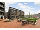 Exterior view of community courtyard with fountain, landscaping, and seating areas at 904 Veterans Way, Carmel, IN 46032
