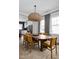 An interior shot of a modern dining room featuring gray curtains and a rattan pendant lamp at 904 Veterans Way, Carmel, IN 46032