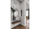 Hallway features modern console table with decor, wine, and glasses and view to dining room at 904 Veterans Way, Carmel, IN 46032