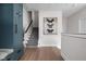 Elegant hallway featuring hardwood floors, staircase, and modern butterfly art, creating a seamless flow at 904 Veterans Way, Carmel, IN 46032