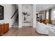 Hallway with a staircase, modern console table, decor and view to dining and kitchen at 904 Veterans Way, Carmel, IN 46032