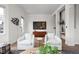 Modern living room features sleek furnishings, wood floors, and striking wall decor at 904 Veterans Way, Carmel, IN 46032