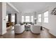Comfortable living area with ample natural light and stylish seating arrangement and view to dining room at 904 Veterans Way, Carmel, IN 46032